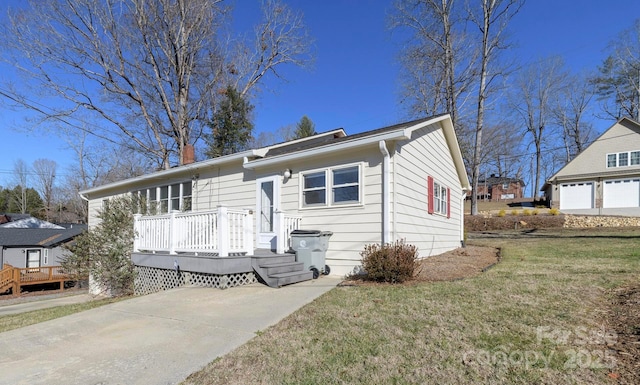 view of front of property with a front yard and a wooden deck