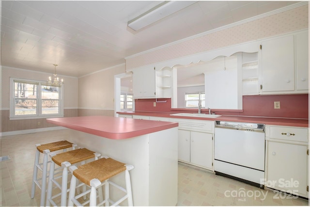 kitchen featuring a center island, dishwasher, a kitchen bar, and white cabinetry