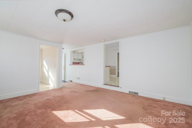 unfurnished room featuring carpet floors and ornamental molding