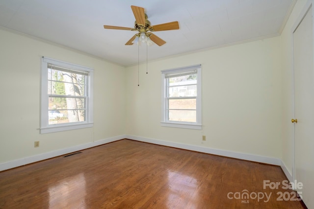 spare room featuring hardwood / wood-style flooring, ceiling fan, and crown molding