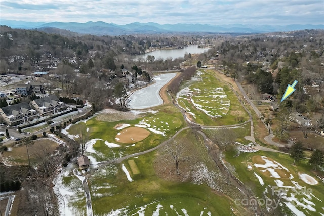 birds eye view of property with a water and mountain view