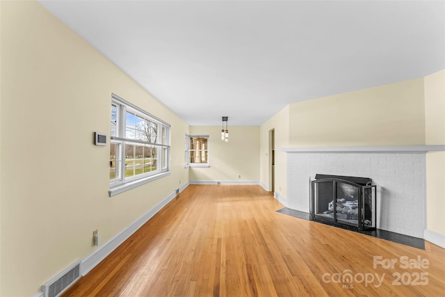 unfurnished living room with wood-type flooring and a fireplace