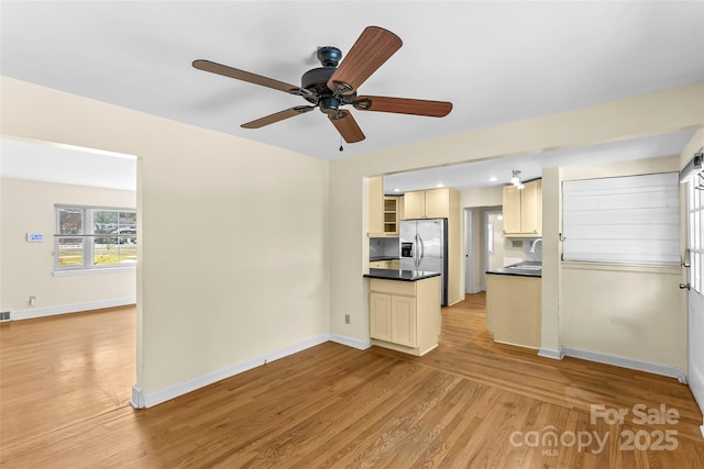 kitchen with stainless steel refrigerator with ice dispenser, sink, light wood-type flooring, and ceiling fan