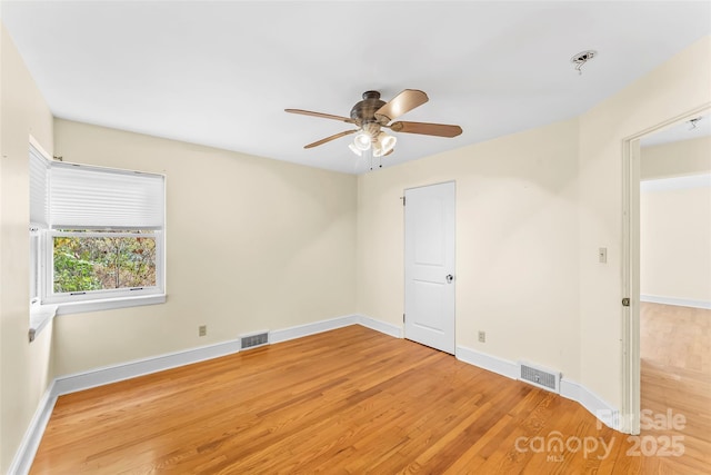 empty room featuring hardwood / wood-style flooring and ceiling fan