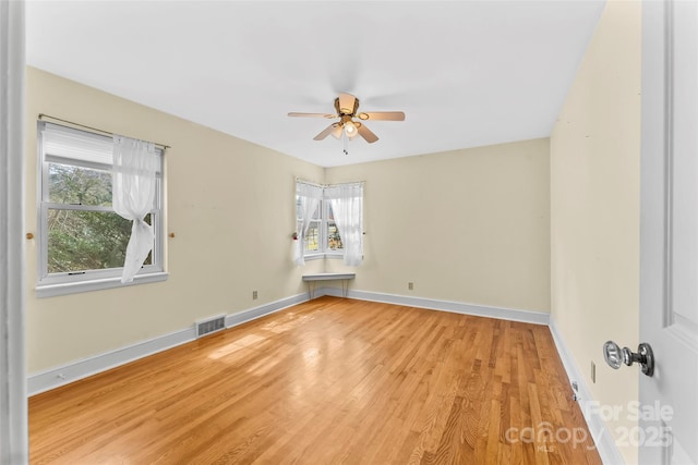 spare room featuring ceiling fan and light hardwood / wood-style floors