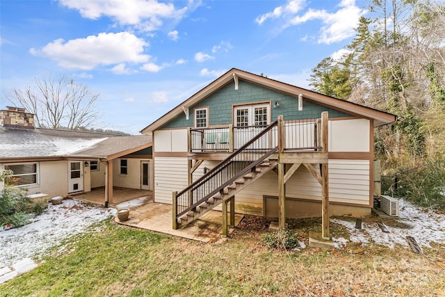 rear view of house featuring a yard and a wooden deck