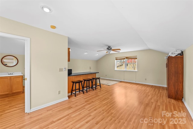 bonus room featuring lofted ceiling, light wood-type flooring, ceiling fan, and sink