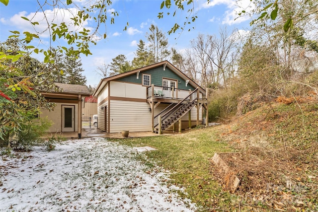 back of property featuring a deck