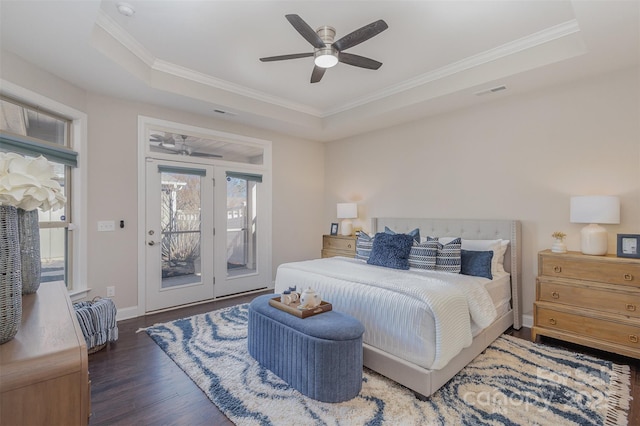 bedroom featuring ceiling fan, dark hardwood / wood-style floors, a raised ceiling, access to exterior, and crown molding