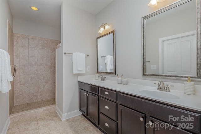 bathroom featuring vanity and a tile shower