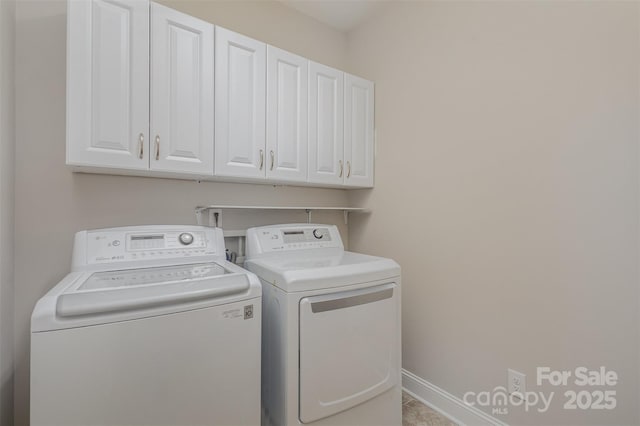 washroom featuring separate washer and dryer and cabinets