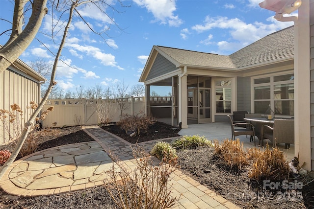 view of patio / terrace featuring a sunroom