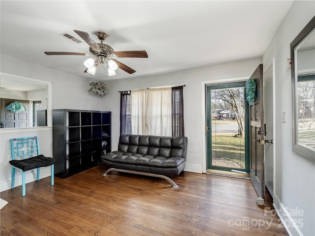 sitting room with ceiling fan and hardwood / wood-style floors