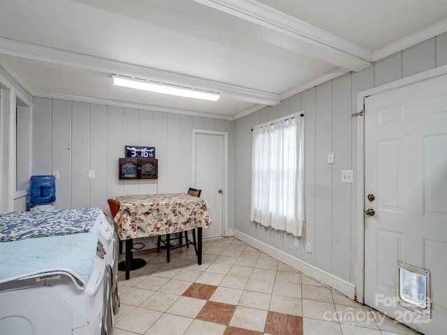 interior space featuring light tile patterned flooring, ornamental molding, and wood walls