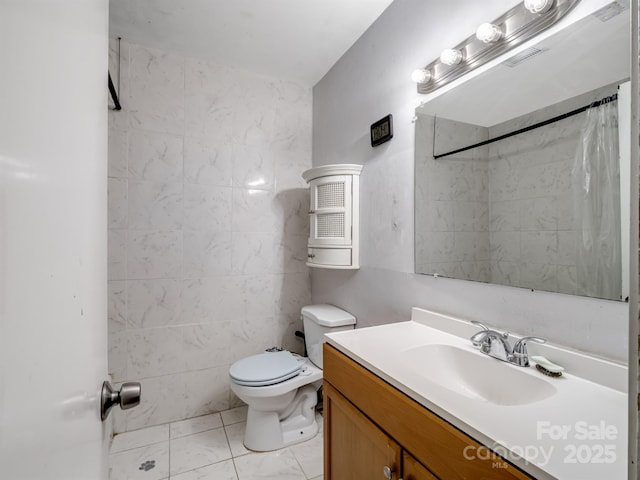 bathroom featuring toilet, tile walls, walk in shower, and vanity