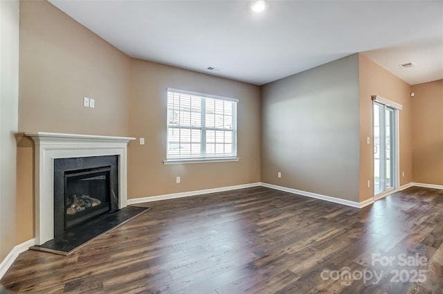 unfurnished living room with dark wood-type flooring