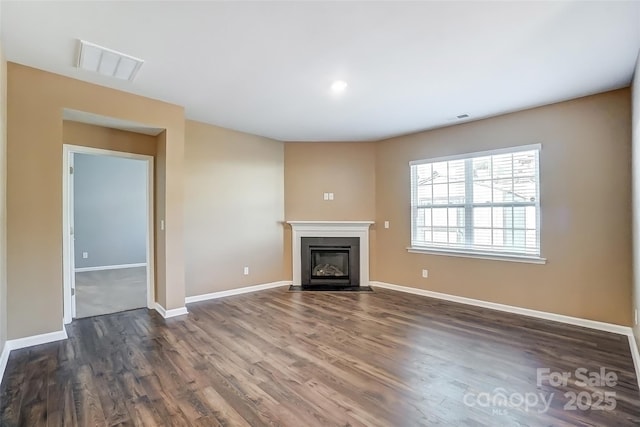 unfurnished living room featuring dark wood-type flooring