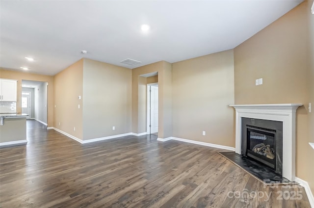 unfurnished living room with dark wood-type flooring