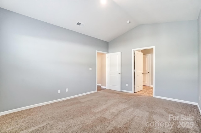 unfurnished bedroom featuring light colored carpet and high vaulted ceiling