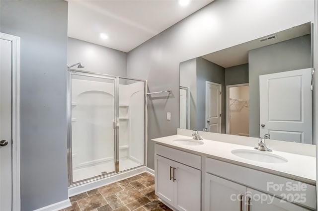 bathroom with an enclosed shower and vanity