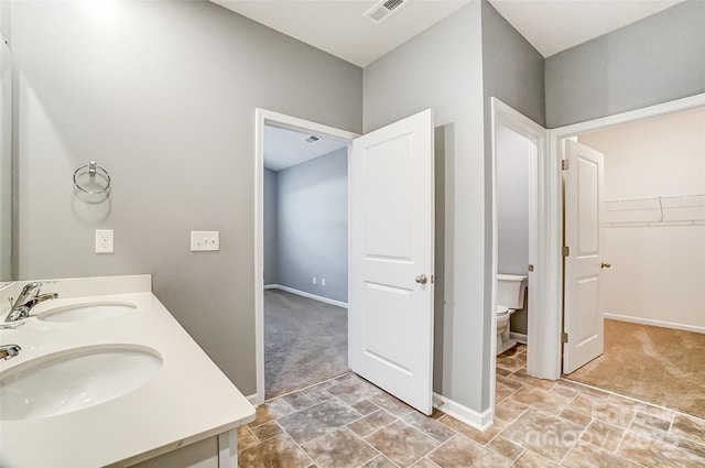 bathroom with toilet and vanity