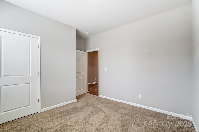 unfurnished bedroom featuring a closet and light carpet