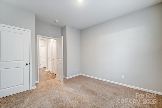 unfurnished bedroom with light colored carpet