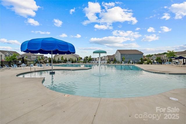 view of swimming pool featuring pool water feature and a patio area