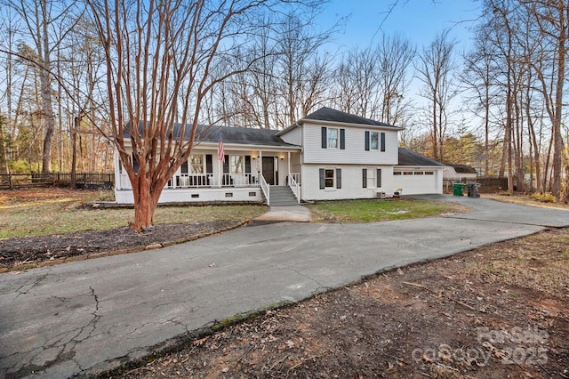 split level home featuring a porch and a garage