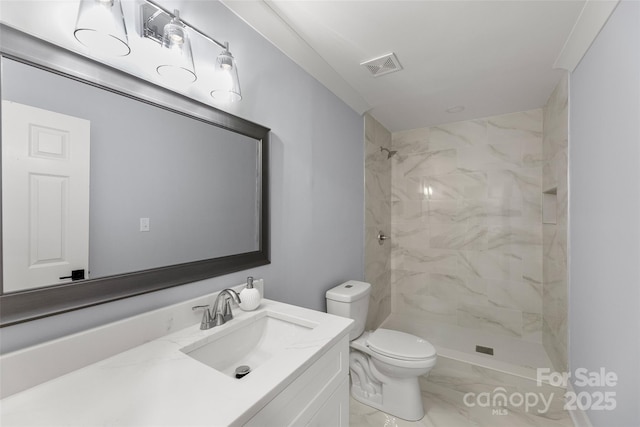 bathroom featuring vanity, toilet, and tiled shower