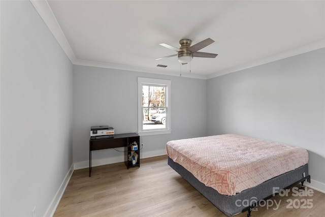 bedroom with ceiling fan, crown molding, and light wood-type flooring