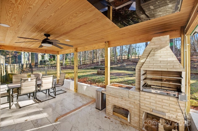 view of patio / terrace with ceiling fan and exterior fireplace