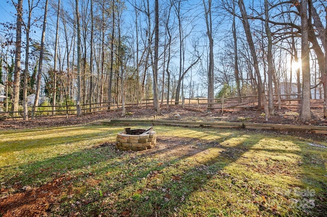 view of yard with a fire pit