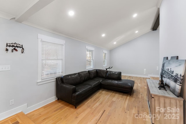 living room featuring ornamental molding, lofted ceiling, and wood-type flooring