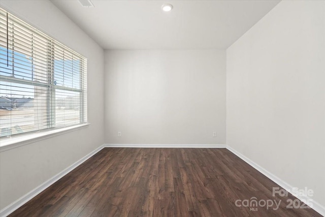 empty room featuring dark wood-type flooring