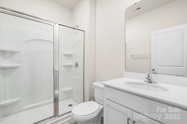 bathroom with an enclosed shower, vanity, and toilet