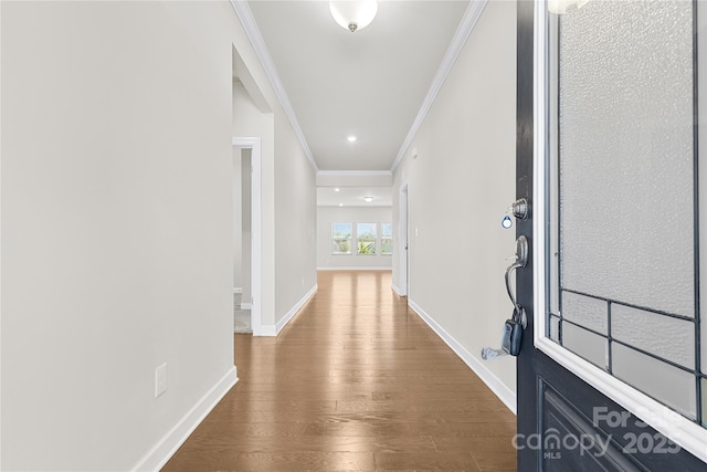 hallway with hardwood / wood-style floors and ornamental molding