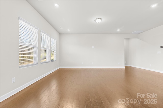 spare room with wood-type flooring