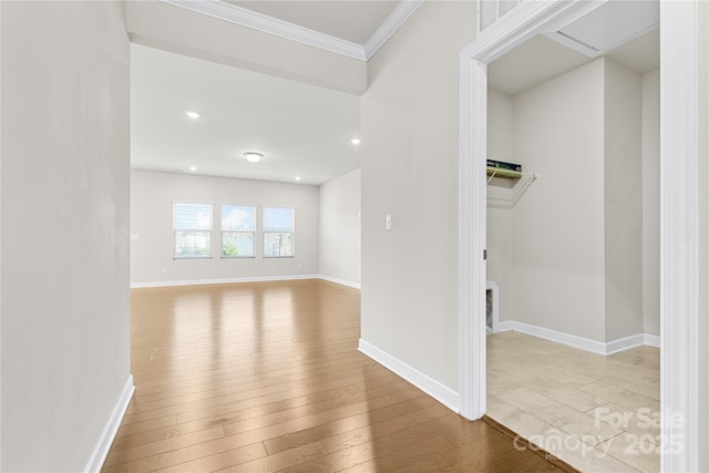 interior space with crown molding and light hardwood / wood-style floors