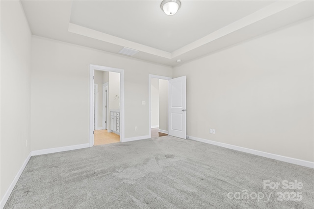 9307 Dufaux Dr, Charlotte, NC 28278 - unfurnished bedroom with a tray ceiling, visible vents, light carpet, and baseboards