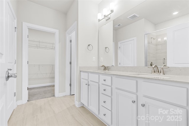 9307 Dufaux Dr, Charlotte, NC 28278 - full bath with visible vents, a sink, a stall shower, and double vanity
