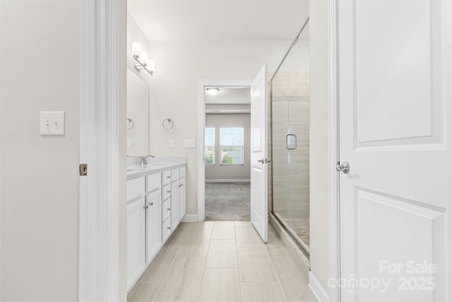9307 Dufaux Dr, Charlotte, NC 28278 - full bathroom with a sink, tile patterned flooring, double vanity, baseboards, and a shower stall