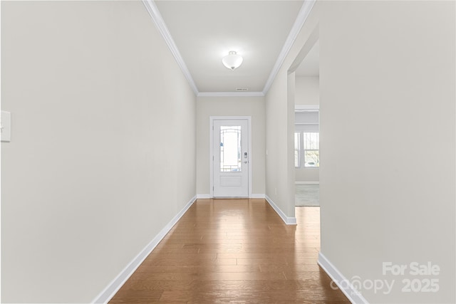 9307 Dufaux Dr, Charlotte, NC 28278 - doorway featuring baseboards, ornamental molding, and hardwood / wood-style floors