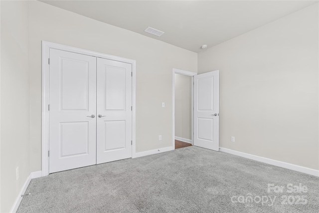 9307 Dufaux Dr, Charlotte, NC 28278 - unfurnished bedroom with visible vents, carpet flooring, baseboards, and a closet