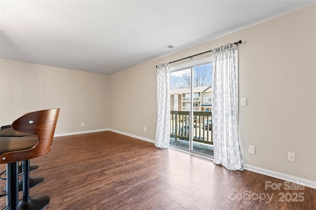 unfurnished room featuring dark hardwood / wood-style flooring