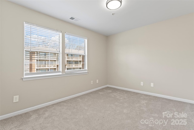 unfurnished room with light colored carpet