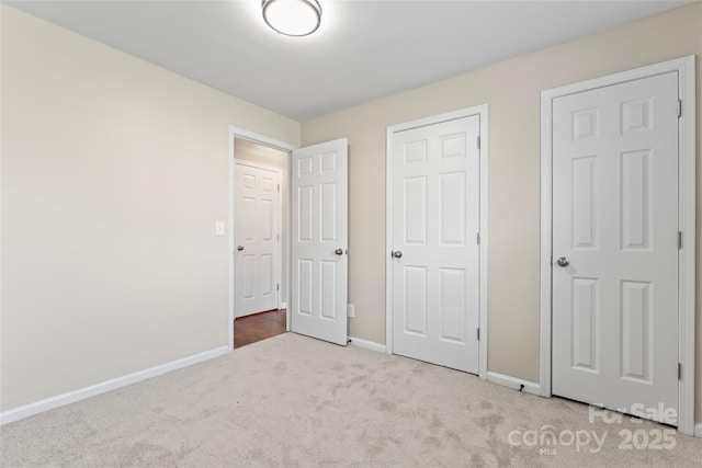 unfurnished bedroom with light colored carpet