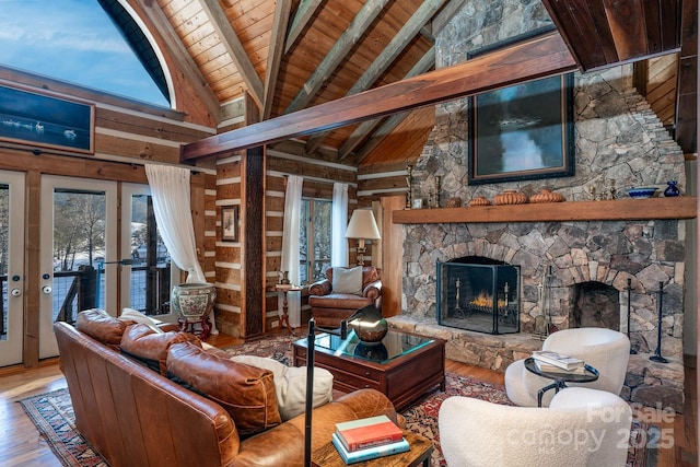 living room with wood ceiling, wood-type flooring, beamed ceiling, a fireplace, and high vaulted ceiling