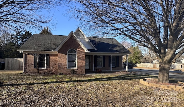 view of front of home with covered porch and a front lawn