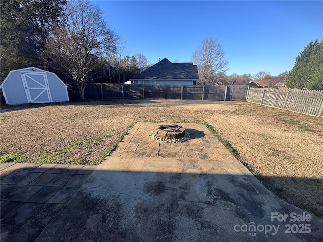 view of yard with a patio, an outdoor fire pit, and a storage unit